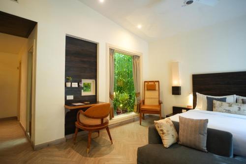 a bedroom with a bed and a desk and a chair at The Solluna Resort in Marchula