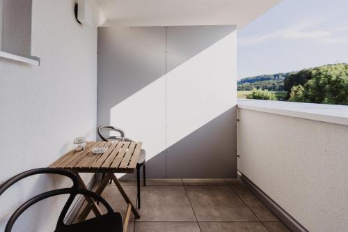 a table and chairs in a room with a window at Ewitsch 13 - Hotel Garni in Berghausen