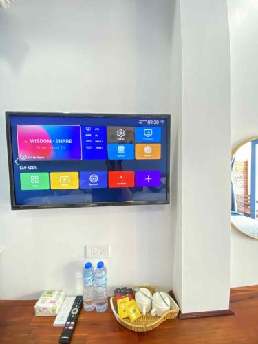 a flat screen tv hanging on a wall at Sadakham Legend Hotel in Luang Prabang