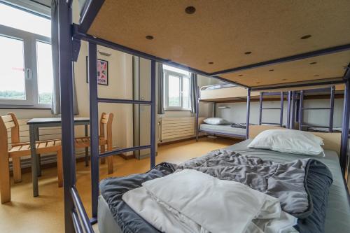 a bedroom with a bunk bed in a room at Auberge de Jeunesse de Bouillon in Bouillon