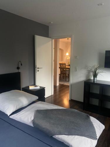 a bedroom with a bed and a table and a room at Ferienwohnung Paradies Hella in Kippenheim
