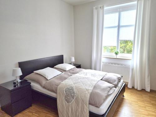 Ένα ή περισσότερα κρεβάτια σε δωμάτιο στο Das Nest Boardinghouse Hamburg Niendorf