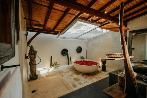 a bathroom with a large tub and a window at CALA NINETA Private Villa in Dalung