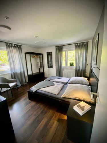 a large bedroom with a large bed and a table at Ferienwohnung Paradies Hella in Kippenheim