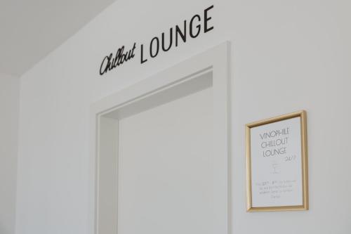 a door with a sign that reads entry lounge and a picture at Ewitsch 13 - Hotel Garni in Berghausen