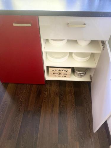 a drawer in a cabinet with a box in it at Ferienwohnung Paradies Hella in Kippenheim