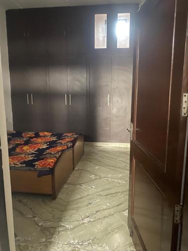 a bedroom with a bed and a door to a room at Swamiji niwas in Morādābād