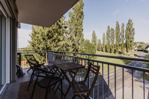a patio with a table and chairs on a balcony at Ewitsch 13 - Hotel Garni in Berghausen