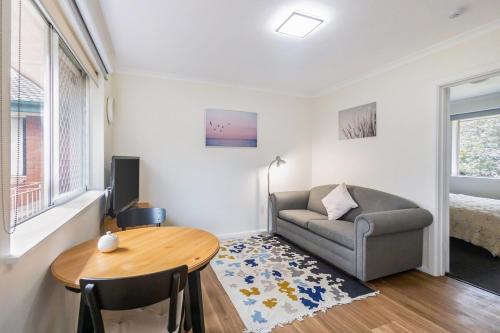 a living room with a couch and a table at Yarralumla Apartment Stay Queen Bed and Sofa Bed Free Parking in Yarralumla