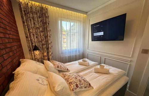 a bedroom with a bed with two towels on it at Willa Piastowska in Polanica-Zdrój