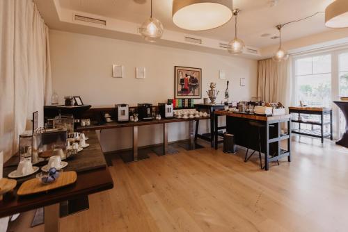 a large room with tables and appliances in it at Ewitsch 13 - Hotel Garni in Berghausen