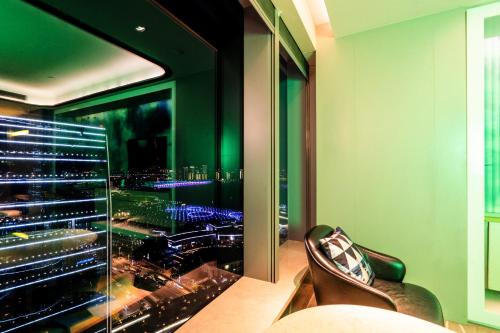a room with a large window with a view of a city at W Suzhou - Jinji Lake in Suzhou