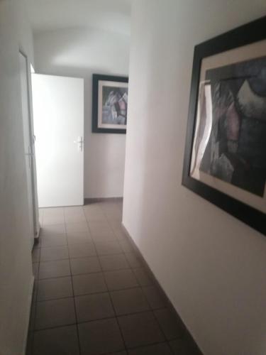 a hallway with two pictures on the wall and a door at Ubytování Louny in Louny