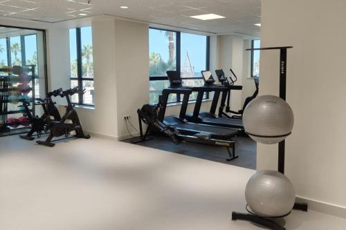 a gym with treadmills and a table with exercise bikes at PONTIANA Thalasso Hotel in Oropesa del Mar