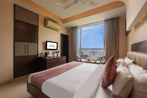 a bedroom with a large bed and a window at Hotel Admire Inn Sector-50 by ASPL in Noida