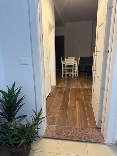 a hallway leading to a dining room with a table at Halim zeneli in Tirana