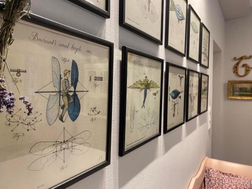 a group of drawings on a wall in a room at Grafit vendégház in Nagyrákos