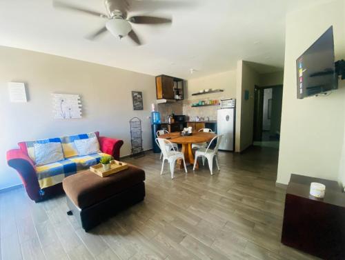 a living room with a couch and a table at Departamentos Raices - Jardines del Lago in Mexicali
