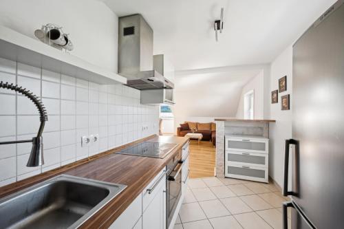 a kitchen with a sink and a stove at Cosy Worker Apartment Olpe in Olpe
