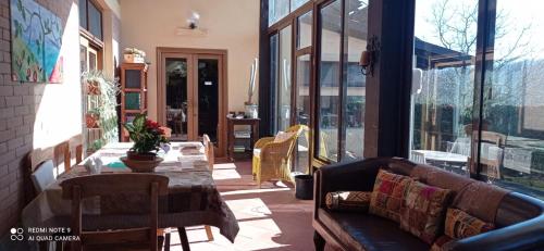 a living room with a couch and a table on a patio at Agriturismo il fragolino in Bassano Romano