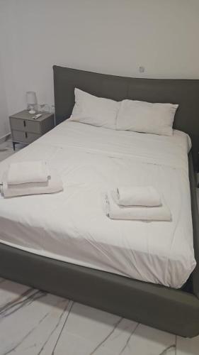 a white bed with two towels on top of it at The St Pauls Bay Escape Suites by 360 Estates in St Paul's Bay
