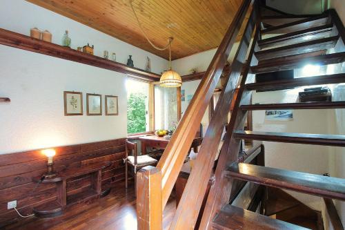 a room with a wooden staircase in a house at Chalet Giove in Belluno