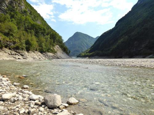a river with rocks in the middle of a mountain at Chalet Giove in Belluno