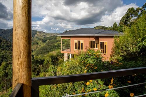 a house with a view of the mountains at Burunga Gorilla Lodge in Kisoro