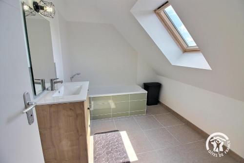 a bathroom with a sink and a skylight at L'ormeau in Frehel