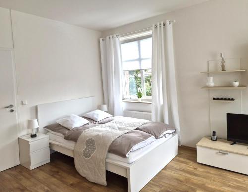 Ένα ή περισσότερα κρεβάτια σε δωμάτιο στο Das Nest Boardinghouse Hamburg Niendorf