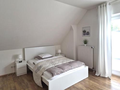 Ένα ή περισσότερα κρεβάτια σε δωμάτιο στο Das Nest Boardinghouse Hamburg Niendorf
