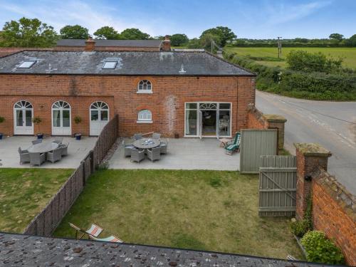 an aerial view of a brick building with a patio at The Ostlery in Tunstead