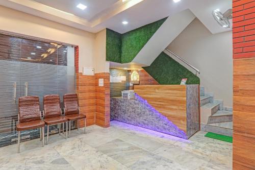 a waiting room with chairs and a staircase at Hotel O Surya Galaxy in Kānpur