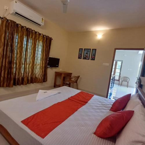 a bedroom with a large bed with red pillows at Lake Park in Pūvār