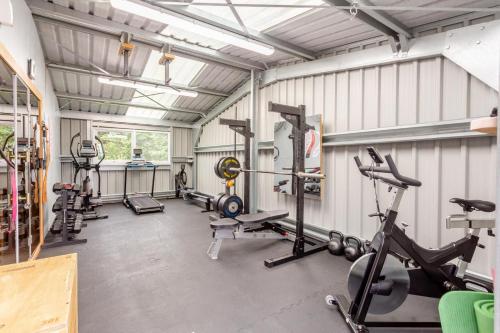 a gym with several treadmills and exercise machines at 2 Bed in Newtonmore oc-d32413 in Newtonmore