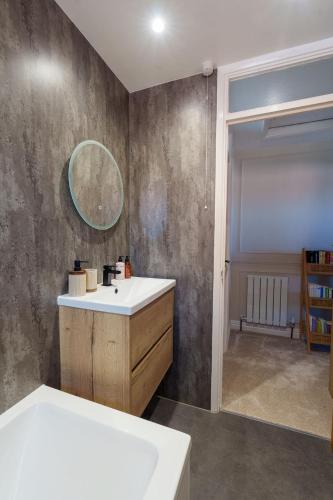 a bathroom with a sink and a mirror at 2 Bed Family Home - The Retreat in Plymouth