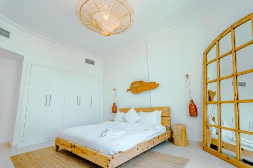 a bedroom with a bed with a wooden headboard at Glamorous Modern 2BHK in Yas Island 324 in Abu Dhabi