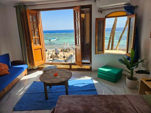 a living room with a view of the ocean at Sirena Dahab in Dahab