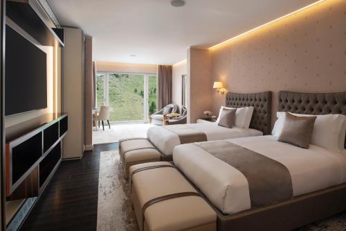 a hotel room with two beds and a television at Ayan Zalaat in Ulaanbaatar