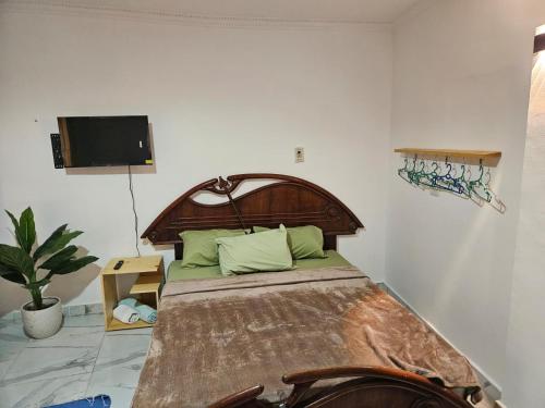 a bedroom with a large bed with a wooden headboard at Sirena Dahab in Dahab