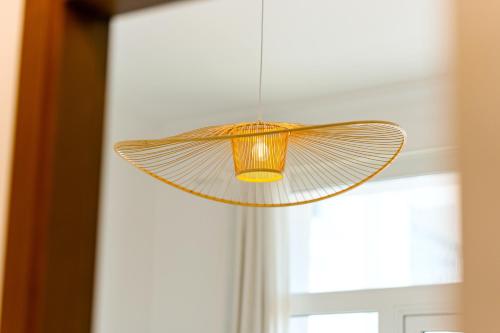 a light fixture hanging in front of a window at Glamorous Modern 2BHK in Yas Island 324 in Abu Dhabi