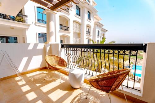 a balcony with chairs and a view of a building at Glamorous Modern 2BHK in Yas Island 324 in Abu Dhabi