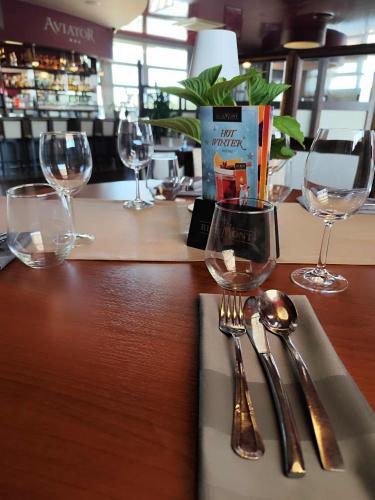 a table with wine glasses and utensils on a counter at Aviator Hotel Restauracja & SPA in Pabianice