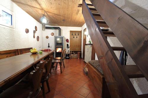 a kitchen with a dining room table and a staircase at Chalet Giove in Belluno