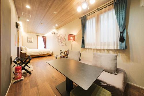 a living room with a table and a couch at GOOD DAY Shinagawa HOTEL in Tokyo