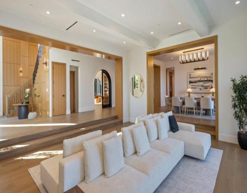 a living room with a white couch and a dining room at Dume Malibu in Malibu