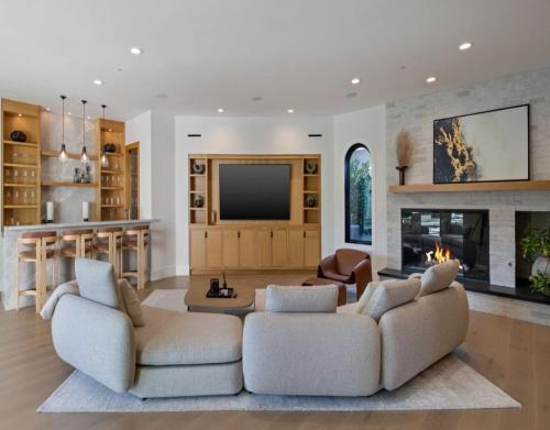 a living room with a couch and a fireplace at Dume Malibu in Malibu