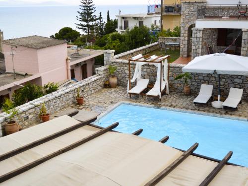 a villa with a pool and a view of the ocean at Malvazios Villas #2 in Gythio