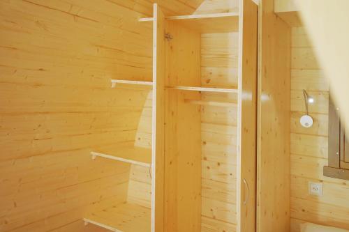 a wooden sauna with wooden walls and shelves at Traumhaftes Bungalow mit Seesicht - ohne privates WC und aktuell ohne Terrasse in Alpnach