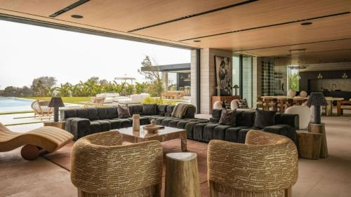 a living room with couches and tables and chairs at The Dume Legacy in Malibu
